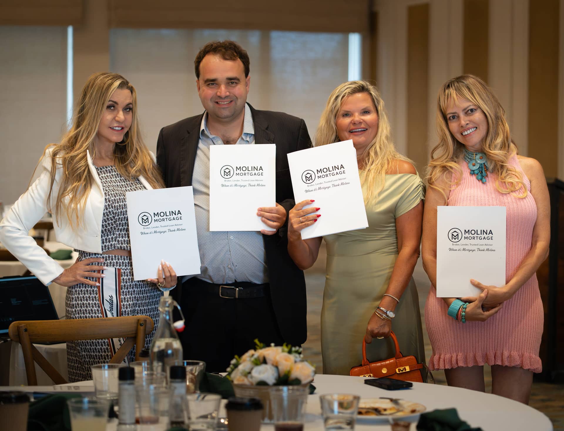 Christopher Molina presenting certificates to agents at a Molina Mortgage masterclass